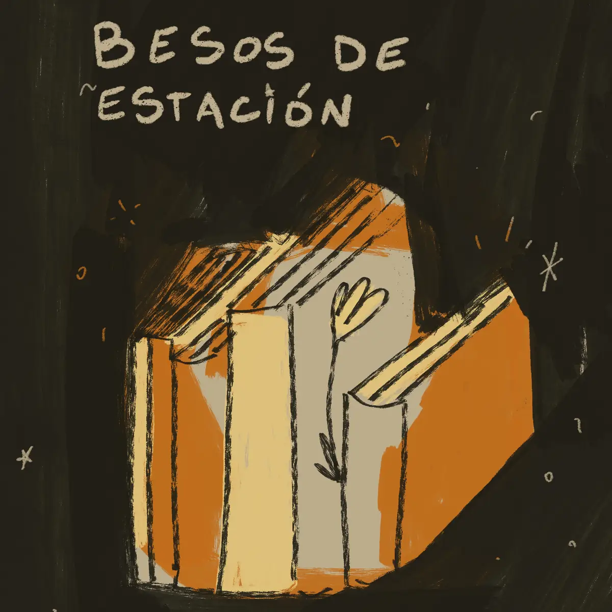Libros naranjas y crema apoyados en la oscuridad, con «Besos de estación» escrito a mano